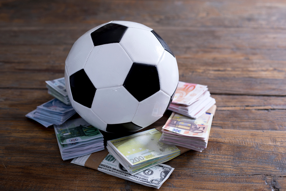 Football on stacks of money