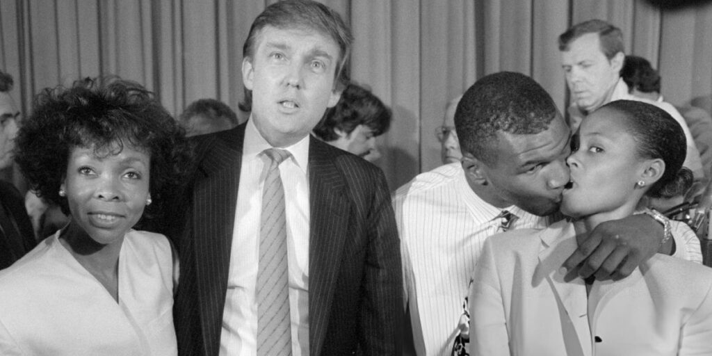 Heavyweight champ Mike Tyson (2nd from R) steals a kiss from his wife Robin Givens (R), while real estate developer Donald Trump and Givens' mother Ruth Roper (L)