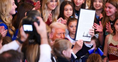 President Donald Trump signs an executive order banning transgender athletes from women’s sports in the East Room of the White House