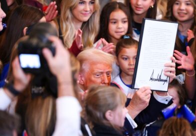 President Donald Trump signs an executive order banning transgender athletes from women’s sports in the East Room of the White House