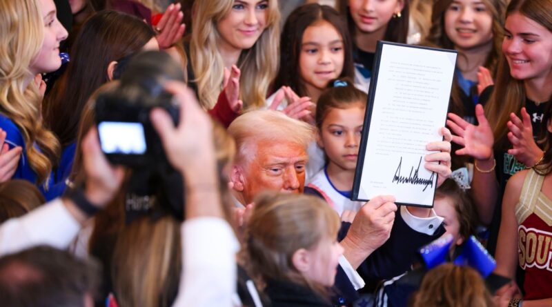 President Donald Trump signs an executive order banning transgender athletes from women’s sports in the East Room of the White House