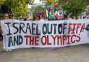 Protesters holding a banner in Manchester to remove Israel from FIFA and the Olympics