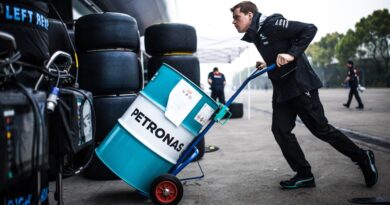 Racing engineer with Petronas barrel of fuel