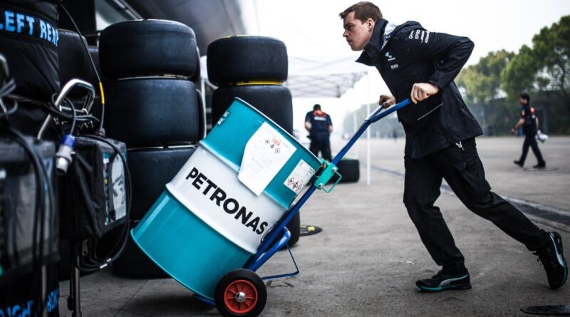 Racing engineer with Petronas barrel of fuel